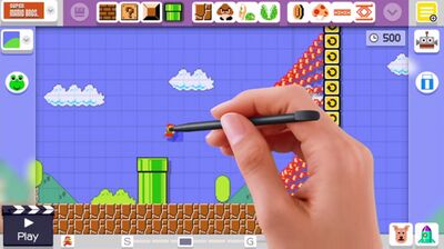 The player’s hand dragging around assets in Super Mario Maker to make levels