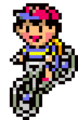 Ness riding his bicycle.